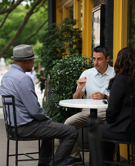 Three people at an outdoor cafe table